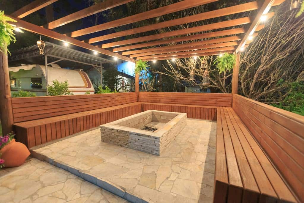 An Empty Fire Pit Surrounded with Brown Wooden Bench making your concrete patio stand out